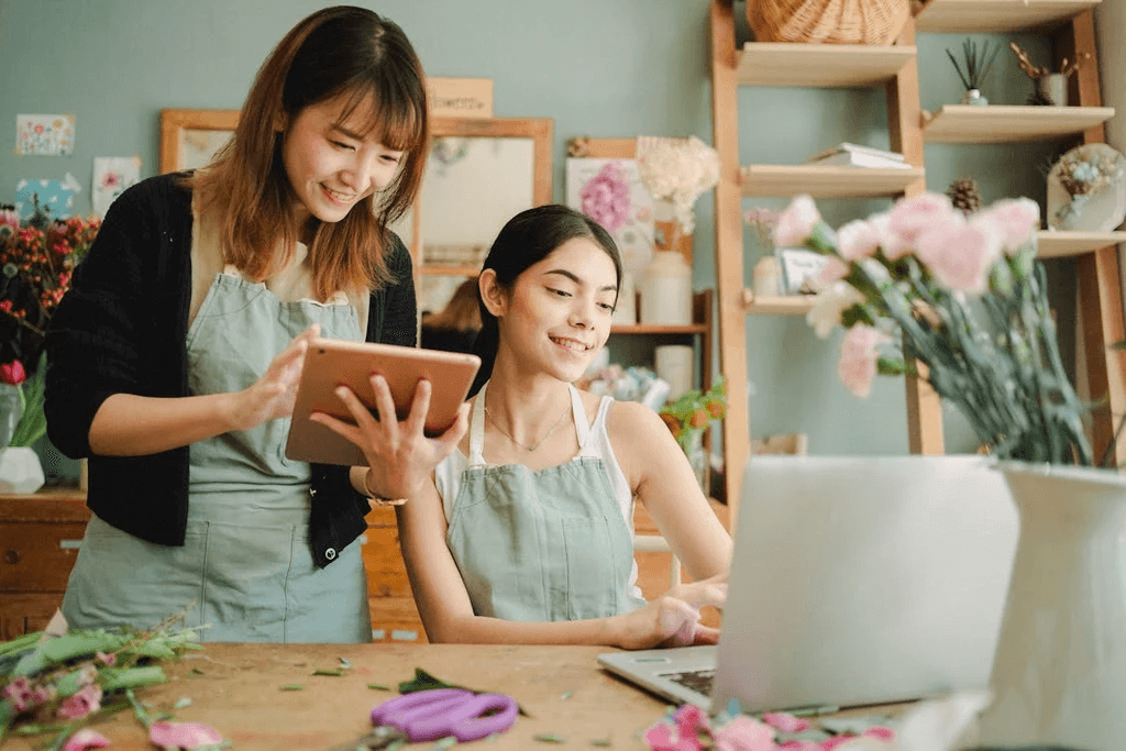 A photo of two businesswomen brainstorming on their store